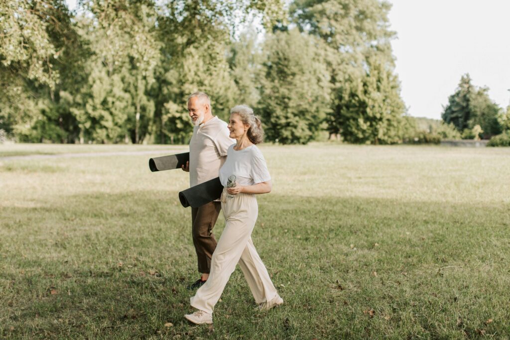 mobility and back pain support for older adults staying active outdoors with yoga mats
