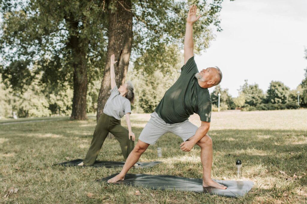 mobility and back pain support for older adults staying active outdoors with yoga mats